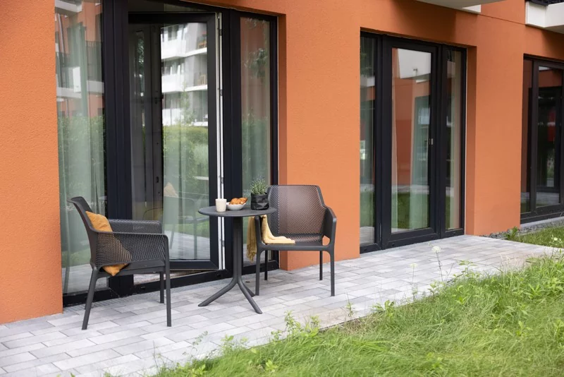 Terrace of The House of Co with two chairs and a small table for co-living in Berlin.